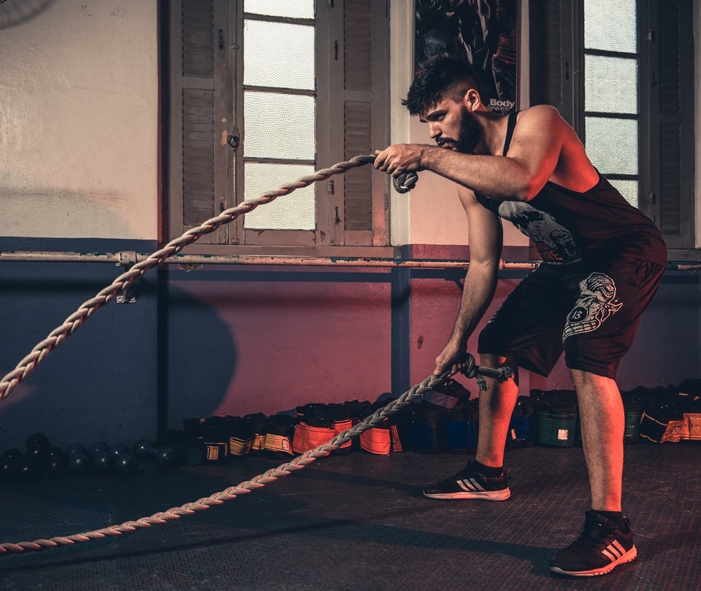 Bearded man lifting ropes