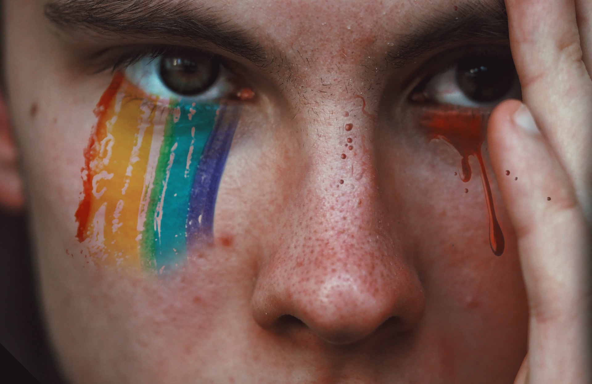 Man's Face with Rainbow Colors Underneath Eyes Man's face with rainbow colors underneath eyes