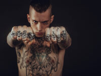 Tough tattoo guy with fists
