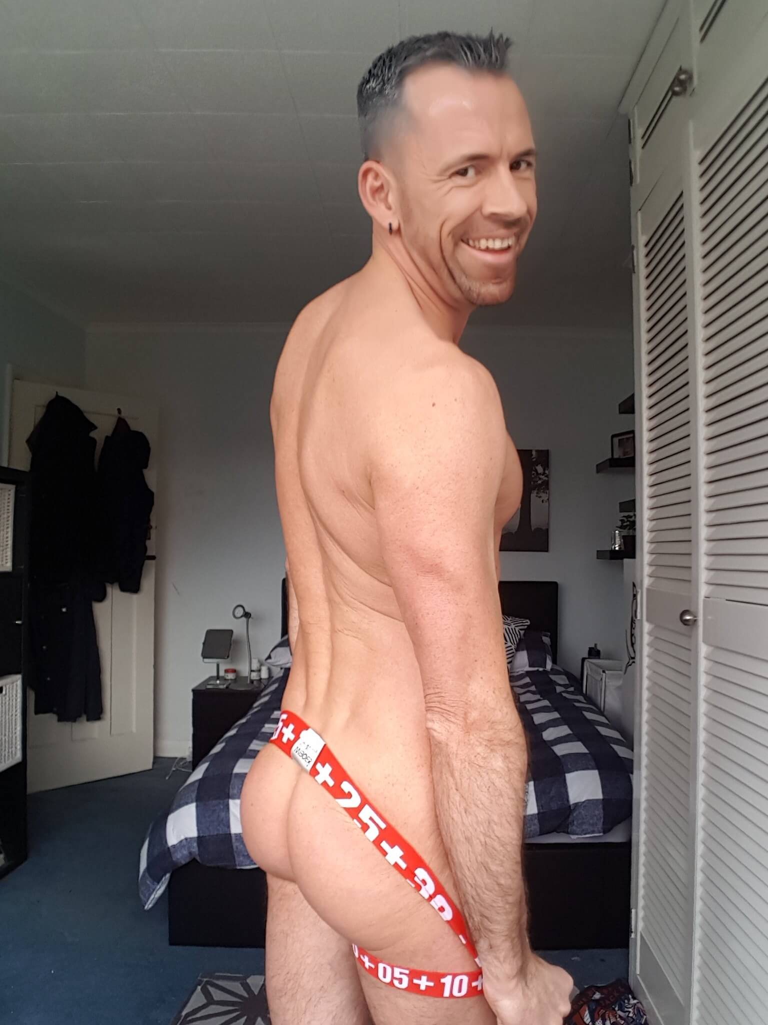 Dave London wearing red numbered jockstrap