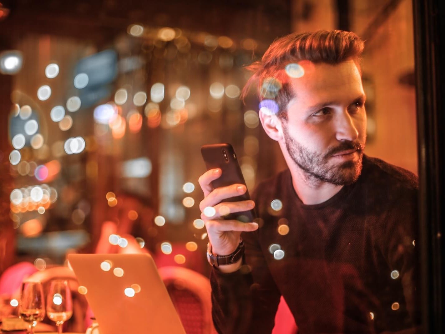 Man Holding Smartphone Looking Away Man holding smartphone looking away