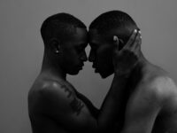 Shirtless male couple embracing