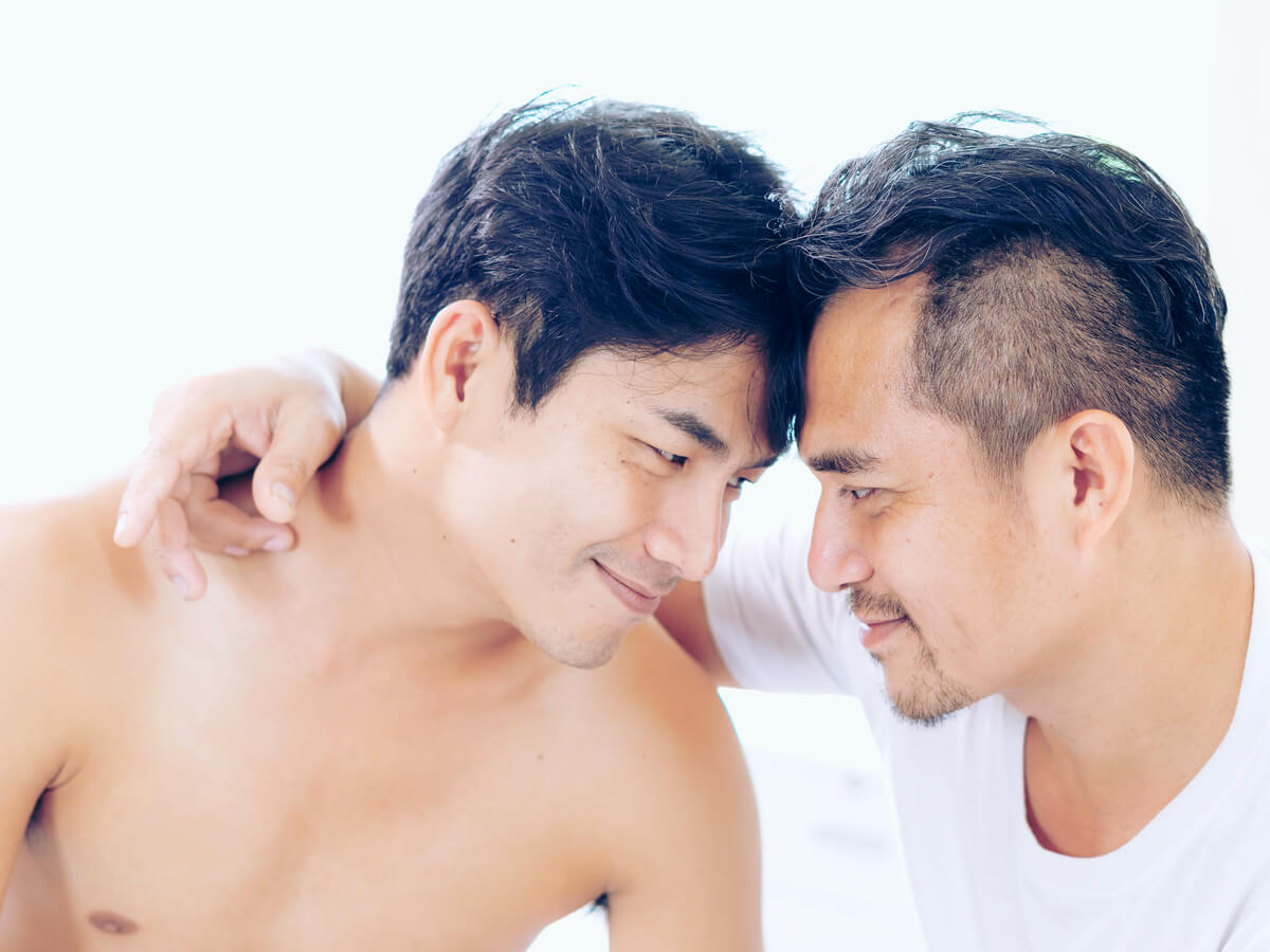 Gay couple with heads together
