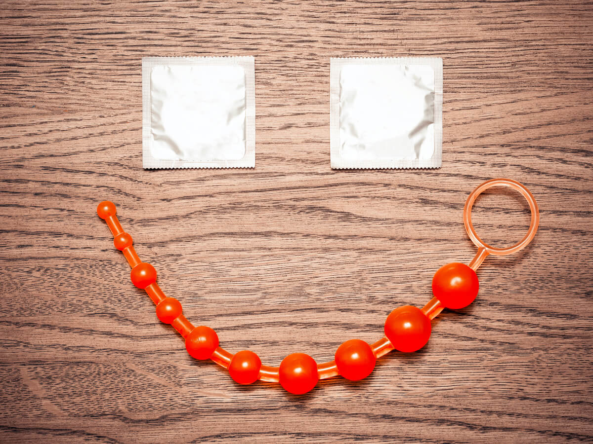 Happy face using condoms and anal beads
