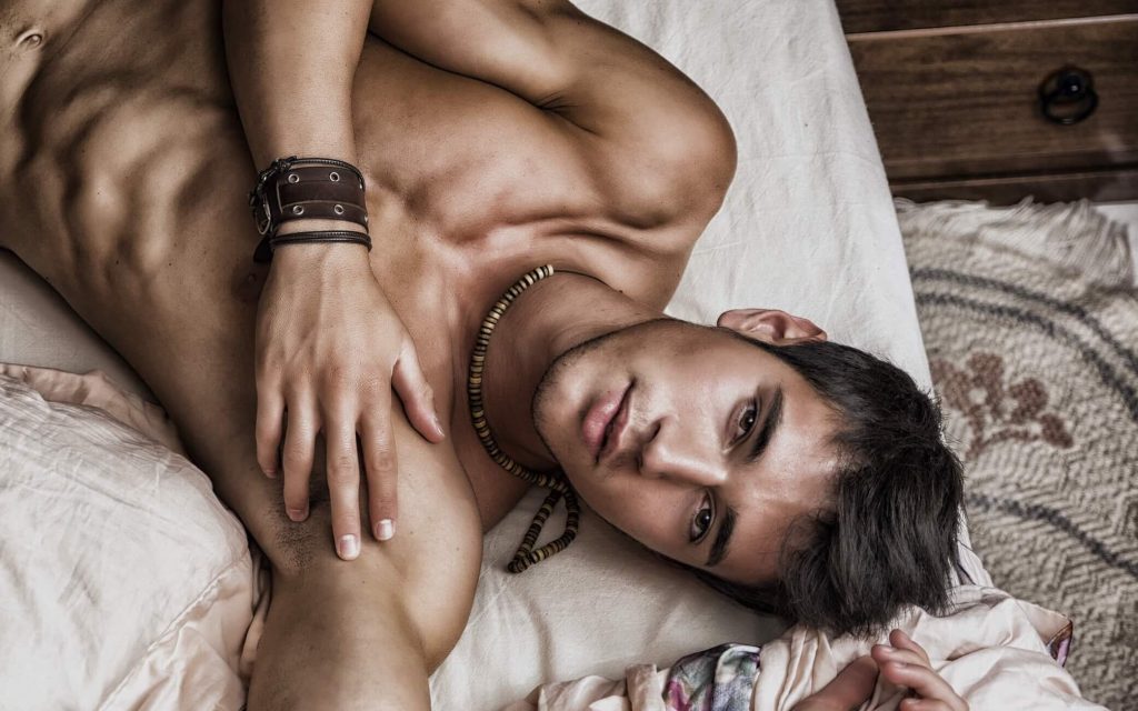 Sinewy Young Man Lying on Bed Shirtless sinewy man lying on bed face up